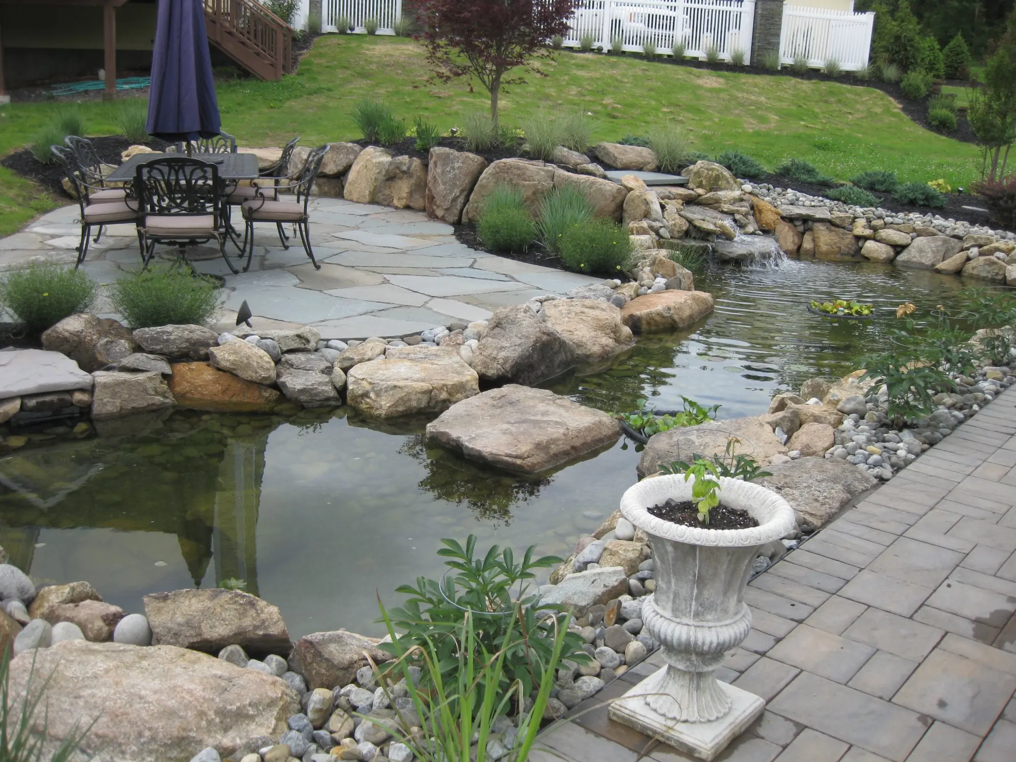 Koi pond with stone terrace and outdoor seating